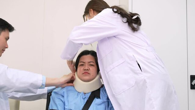 Young Doctors checking patients with neck injuries caused by lying pillow in the wrong position causing stiff neck injury, Doctor writing prescriptions to patients. Doctor talk consults patient.
