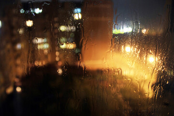Large drops of rain on the glass window