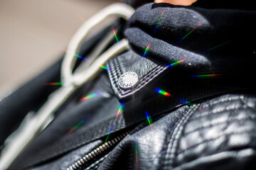 Rainbow highlights on a studded leather jacket