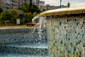 Water from the fountain falls with splashes