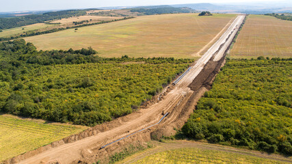 Aerial view of gas and oil pipeline construction. Pipes welded together. Big pipeline is under construction.