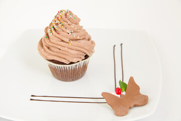 Chocolate muffin with frosting top and sprinkles. With decoration - 769785109