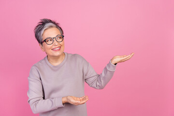 Photo of grandmother in dyed haircut business woman investor with experience promoting empty space...