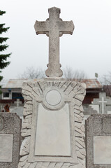 Close-up of cross on a tombstone in a cemetery