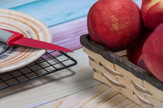 A basket of pelones and a plate with a knife.