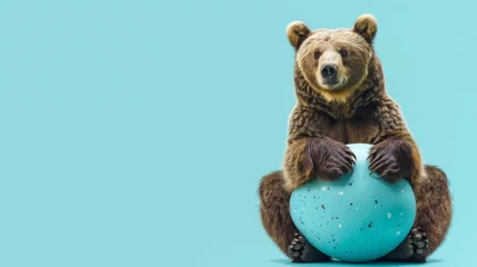 Foto op Aluminium Grizzly bear hugging a large blue egg on blue background - A cute brown bear appears to hug a massive blue egg on a vibrant blue background © Mickey