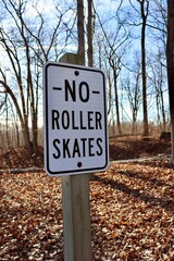 A close view of a no roller skates sign.