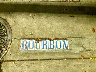 Bourbon Street sign on sidewalk in New Orleans, Louisiana