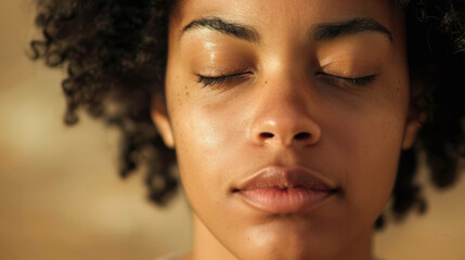 Close-up of a young woman meditating with eyes closed, serene expression, natural beauty, warm tones