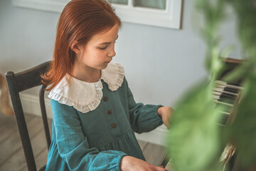 Cute little girl playing the piano at home, learning music, music education, hobbies