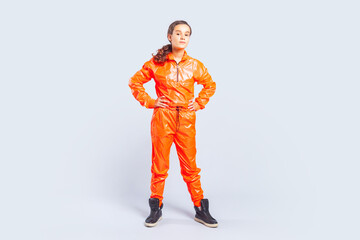 Full length portrait of confident hip-hop dancer teenage girl with brunette hair wearing bright...
