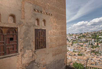 Small windows on Alhambra Palace looking through the city of Granada.