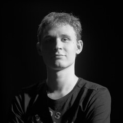 male teenager black and white high contrast short light portrait