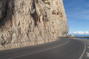 Coastal road winding along a cliff - 769843175