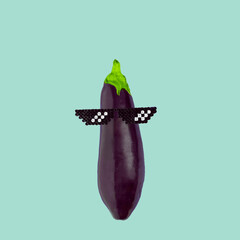 Creative concept eggplant with pixel glasses on green blue background. Food idea.