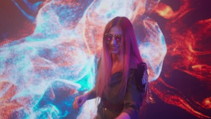 Attractive female on digital wall colorful visual graphic background. Young woman dj dancing, mixing plays music on turntables mixer at night club party.