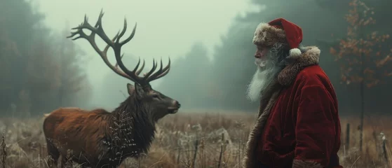 Selbstklebende Fototapeten Deer and Santa Claus © Zaleman