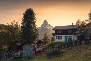 Beautiful sunset over Matterhorn mountain with wooden chalet on hill in rural scene at Switzerland - 769849759