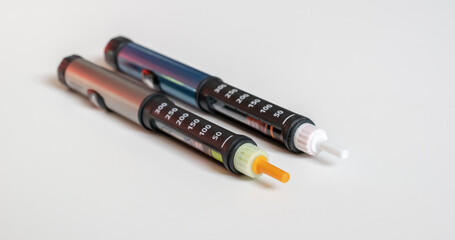 Insulin pen injector.  Insulin pen fill with needle on white background.