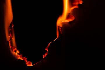 burning paper, glowing edge of paper on a black background