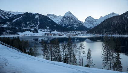 evening scenery in winter, lake Achensee with view to Karwendel mountains and Pertisau, tyrol