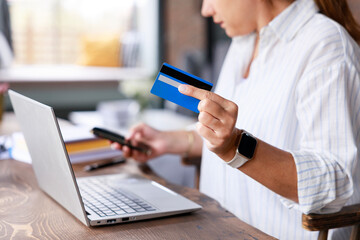 Young freelancer woman shopping online with laptop and credit card