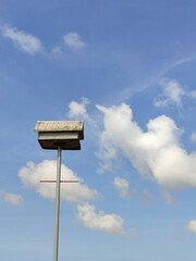 Wooden bird house on the blue sky