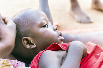 sick african child in an refugee camp, social worker comforting the boy, conflict zone