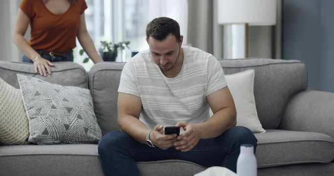 Infidelity, couple and caught internet cheating with fight, conflict or argument about social media. Phone, divorce or breakup with man and woman on sofa in home living room for online communication