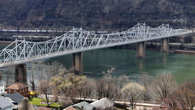 An aerial establishing shot of the Ambridge Bridge over the Ohio River in late winter. Pittsburgh suburbs.