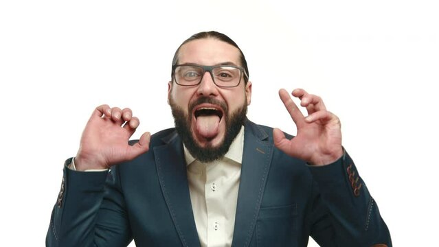 A man in a tailored suit playfully sticking out his tongue, his antics conveying humor against a pristine white background. Camera 8K RAW. 