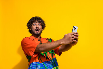 Portrait of ecstatic guy with afro hairstyle wear shirt hold smartphone astonished staring open...