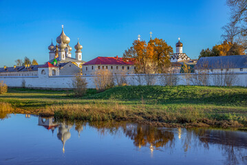 Autumn evening at the walls of the ancient Tikhvin monastery. Leningrad region, Russia - obrazy, fototapety, plakaty