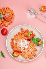 Homemade Belgian Waffles with strawberries. Gluten-free red dessert, fresh fruits and basil