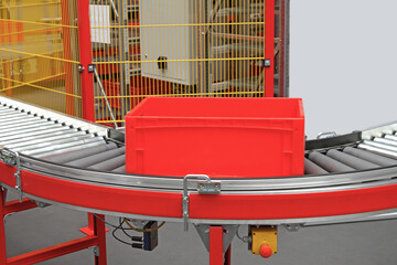 Red Crate at Conveyor Rollers in Automated Distribution Warehouse