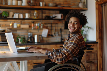 An African-American man in a wheelchair using a laptop on a wooden table, to search for information, telework or study. Disability, inclusion and technology concept.
