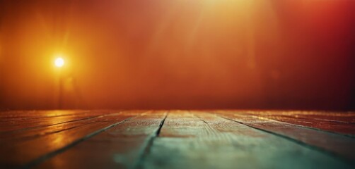   A bright light illuminates a wooden floor in a dark room, with the wooden floor in focus