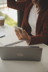 Shot of a asian young business Female working on laptop in her workstation.