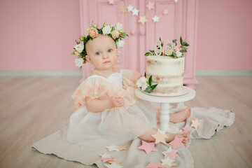 baby girl in cute dress, with cake,  celebrate first birthday 