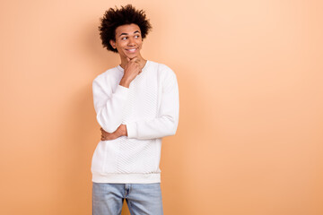 Photo of positive thoughtful man dressed white trendy clothes look interesting news empty space isolated on beige color background
