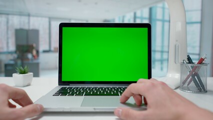 Businessman working on laptop with green screen in Office. Advertising area, workspace mock up.