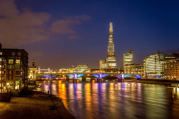 Zelfklevend Fotobehang View of London city skyline on colorful sunset, with Southwark bridge over Thames river and the Shard skyscraper in the middle of the frame. © Nabil