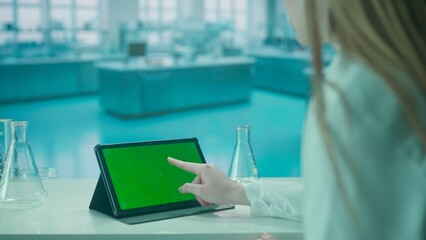 Tablet with Green Screen on Research Biochemistry lab Desk. Advertising area, workspace mock up.