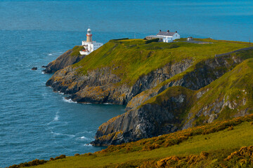 Fototapeta na wymiar Aerial view a lighthouse on a cliff by the sea Dublin, Republic of Ireland