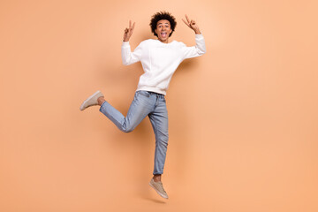 Full length photo of positive crazy cheerful guy have fun good mood nice party v-sign isolated on beige color background