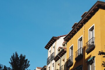 Old-fashioned vintage buildings of different colours in Madrid, Spain. Urban architecture