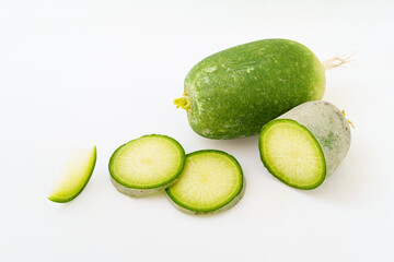 Green radish and radish slices on white background