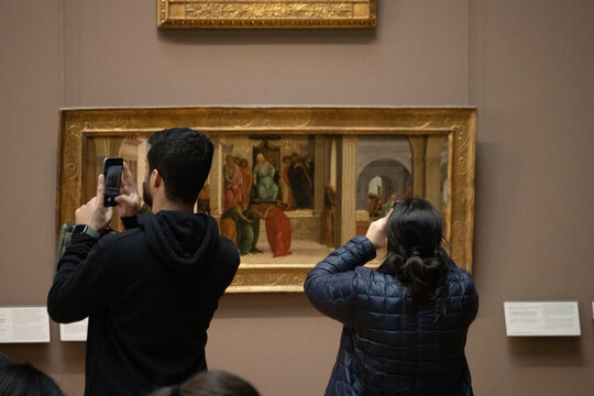 Paris, France, 9 November 2024 : Museum Visitors Photographing Art.