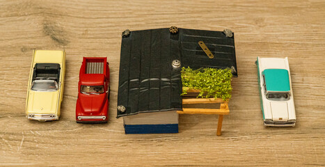 Visitor's cars next to an old farm house.  Model car scene.
