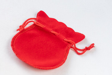 Red drawstring pouch, velvet jewelry bag on white background.  Gift, surprise concept